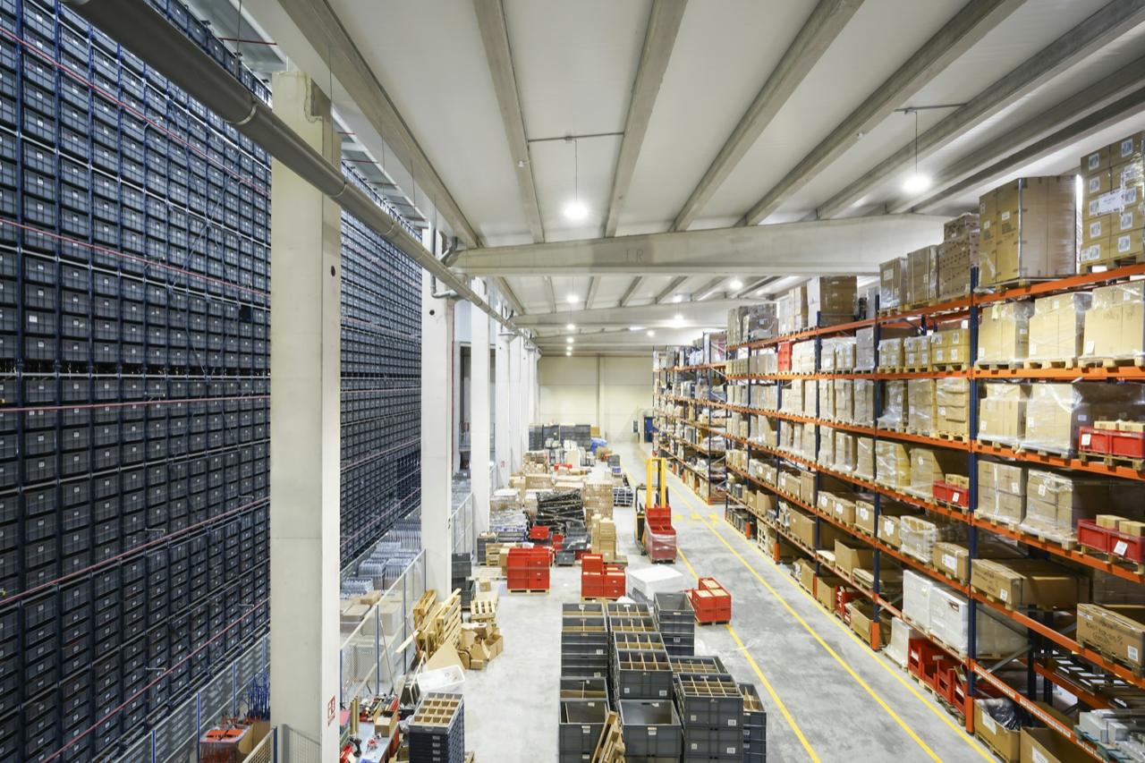 A large distribution warehouse with tall racking and stock ready for dispatch